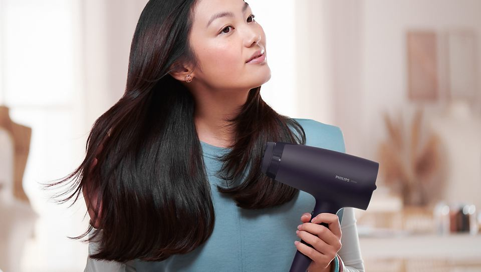 Woman Blow-Dries Her Hair