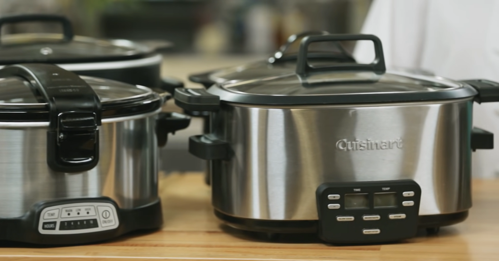 two crockpots on the table- two behind them