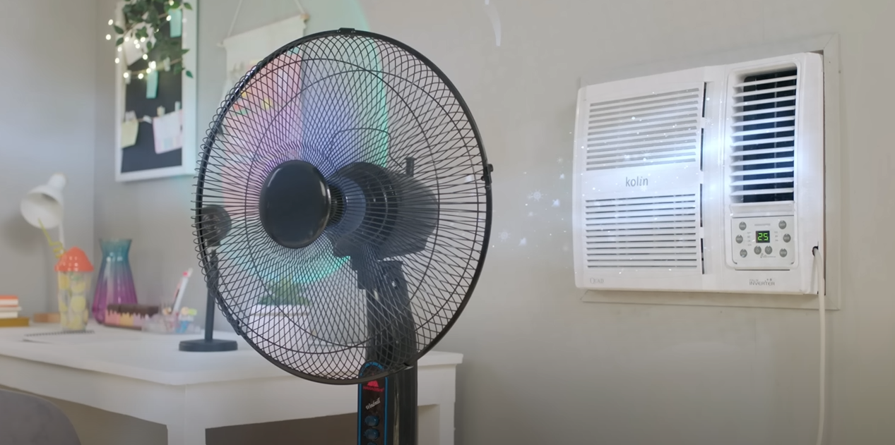 Electric fan in front of air conditioner